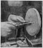Upper view : Using the toe of a keen  in. skew chisel to bore the hole that is to take the tenon of the candlestick upright. Lower view: Marking the diameter of the base with dividers held on the T rest and centered by trial.