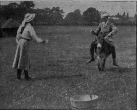 In the ball and bucket race each boy catches a polo ball thrown by a girl partnei stationed at a third of the distance down the course