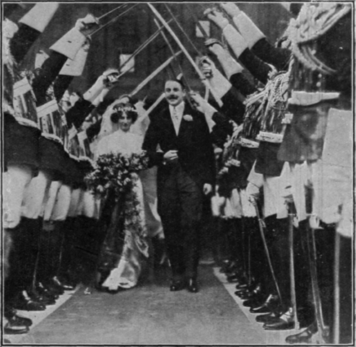 A military wedding the bride and bridegroom passing under an arch of swords