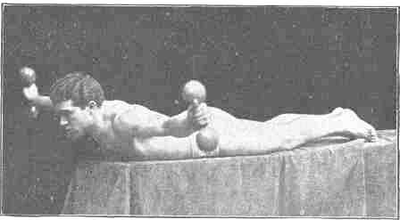 Exercise No 16 and 17: Reclining, arms hanging, raising bells upward and outward from the body, level with shoulders Reversing that motion by bringing bells from position Illustrated in No 15 to position on level with the shoulders, as illustrated in No 16