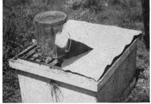 At this time it is best to use an oilcloth in place of the inner cover. (A piece of burlap or canvas will also work. ) Place the oilcloth over the frames and turn back one corner, then invert the feeder pail directly over the frames.