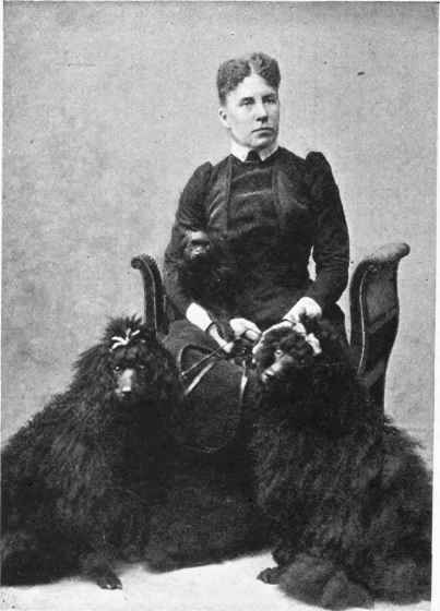 MRS. FRED HUNTER WITH HER POODLES.