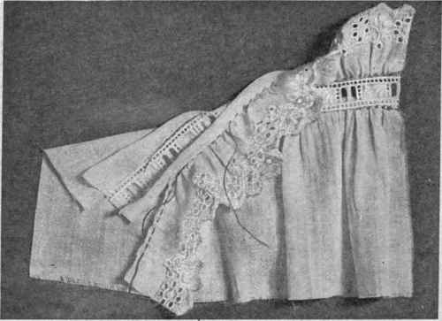 Fig. 157.   Embroidered edging, gathered, and beading used as decoration and finish for gathered edge of garment.