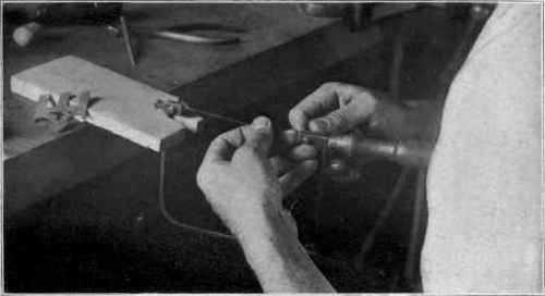 Fig . 29. Placing  new blade in saw frame.