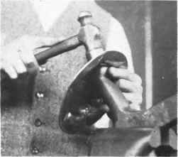 Fig . 65. Planishing' the side of the plate.