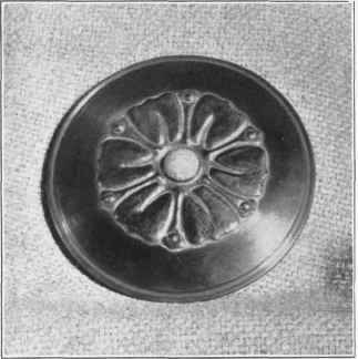 Wig, 135. C hased cover, with stone set in center.