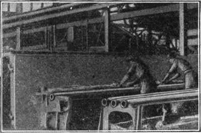 Fig. 189.   Making Cores for Cast Iron Pipe. Cores for pipes are made on a bar. Hay is wound on this bar and then loam is carefully worked into the hay. The core is then dried and given a second coat of mud, dried again, and blackened. It is then placed in the mold.