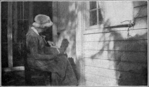 Fig. 50.   Grandmother Allen carding wool by hand.