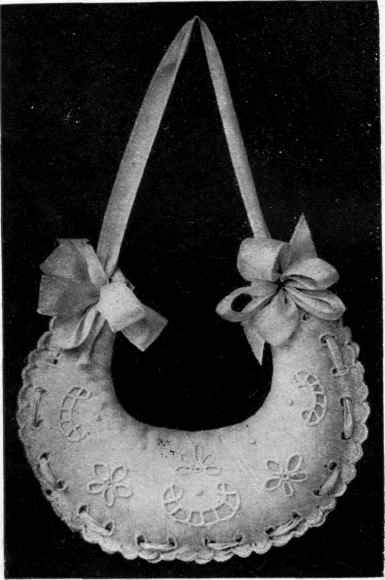 A CRESCENT SHAPED PINCUSHION.