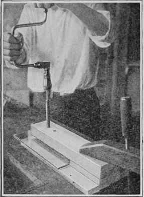 Grinding a hole in plate glass with a brass tube charged with abrasive powder.