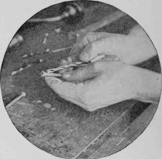 Placing the bit on the shank of the screw to obtain the correct size before boring.