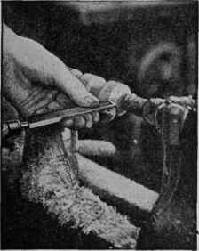 Use a skew chisel to square both ends. Be careful not to cut too close to the live center, to avoid damaging the tool.