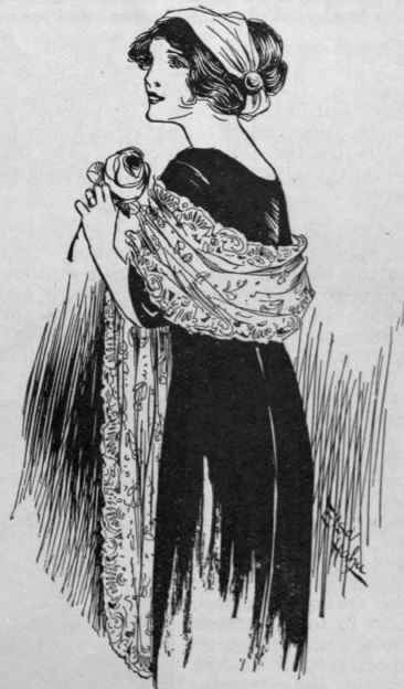 The lace worn as a shoulder scarf. This mode lends a charming finishing touch to an evening gown