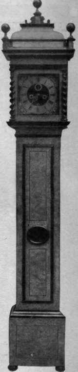 Fig. 4. Fine inlaid walnut grandfather clock, with brass dial. The corkscrew pillars at the angles of the hood are of the Queen Anne period