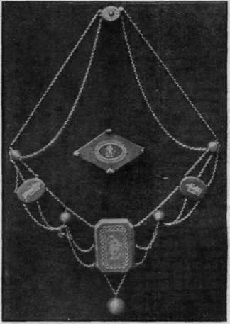 Necklet and brooch of old Wedgwood plaques in green jasper, with balls of green jade and silver chains. The figures and borders on the pieces are in white relief