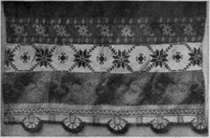 Russian embroidery in blue and red as applied to an apron of scarlet linen