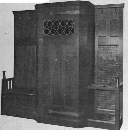 A hall stand which serves several purposes. It accommodates coats and hats, affords a comfortable seat and has a most practical umbrella stand Liberty & Co.