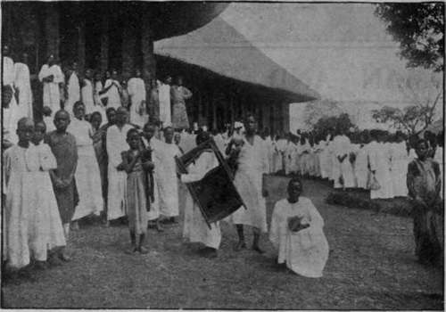 Natives leaving the cathedral, Mengo, Uganda, after a service. The congregation is summoned by a huge drum instead of a church bell Photo, C, W. Hattersley