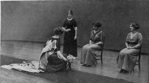 Fig. 2. Rehearsing the first curtsey to the King. In the class the seated figures represent their Majesties. The debutante should hold her bouquet in her right hand just beyond the right knee as she sinks gracefully down in her obeisance