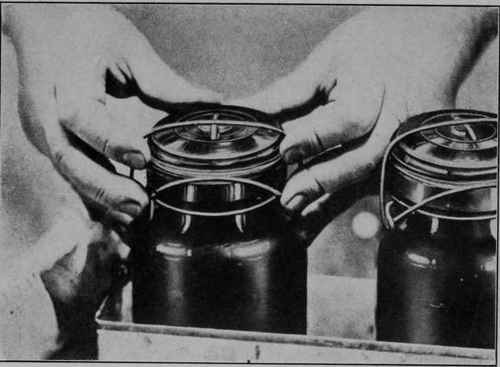 Fig. 4 - Before processing, the tops of the jars are put in place, but not made tight.