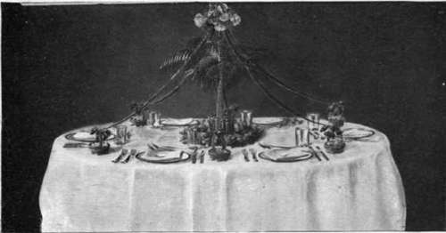 A Table Decorated With Chrysanthemums And Palms