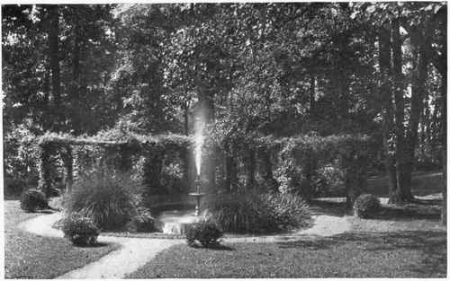 FOUNTAIN AND POOL Fig. 139.   The rustic pergola in the background of the garden fountain is an added allurement to a quiet retreat.   See page 172.