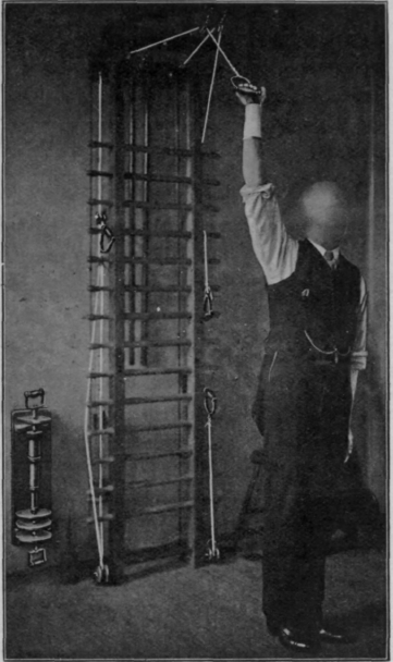 Fig. 143. To show how a patient wearing a cock up splint, and suffering from musculo spiral paralysis, may safely exercise the limb with the weight and pulley. All exercises must be performed with the back to the apparatus