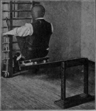 Fig. 50.   The last position for exercise on the sliding seat. Foot piece fixed and flexion of the knee assisted by the pull of the arms. It is evident that this position affords an admirable introduction to the high curtsy sitting position