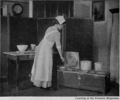 Fig. 14.   A neat working table and worker. Notice the fireless cooker.