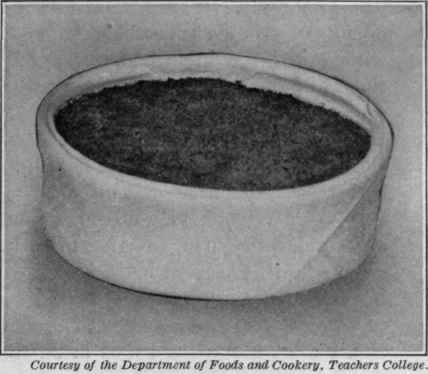 Fig. 32.   A dish of scalloped fish. See page 85. Notice how neatly the cloth is wrapped around the dish in which the fish is cooked.