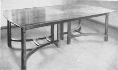 EXTENDING DINING TABLE IN ENGLISH WALNUT.