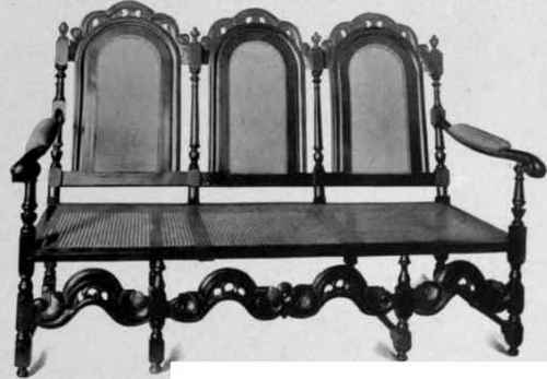 Cane Settle with three chair backs, about 1675.