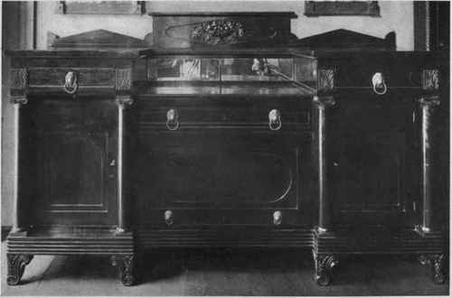 AMERICAN EMPIRE CARVED MAHOGANY SIDEBOARD, ACANTHUS CARVING AND FEET AND LION'S HEAD MOUNTS.