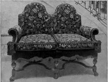 Settee with double hood back and characteristic stretchers.