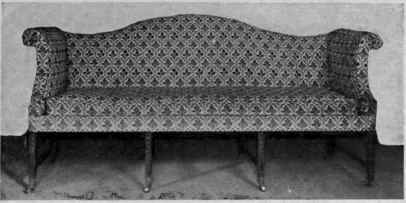 Upholstered Sofa, Shaped Top and Rolled over Arms, Tapered Legs.
