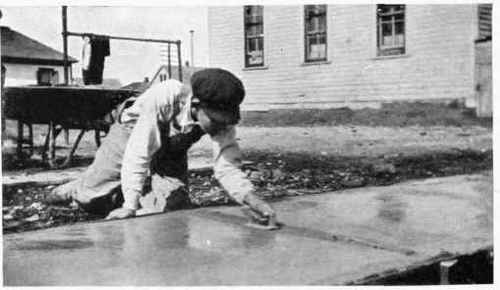 Using a jointer to properly finish the joint between adjoining slabs.