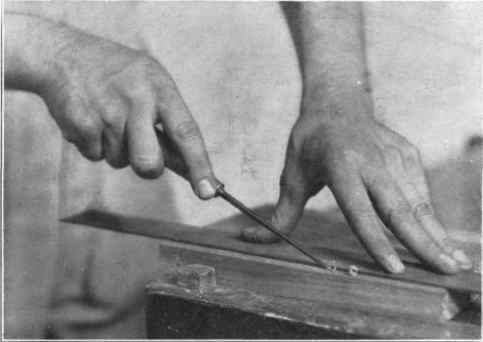 Fig. 176. Guiding a veining tool along a straight edge.